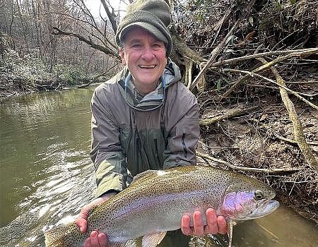 Older gentleman poses with fish caught on wade trip in Blue Ridge