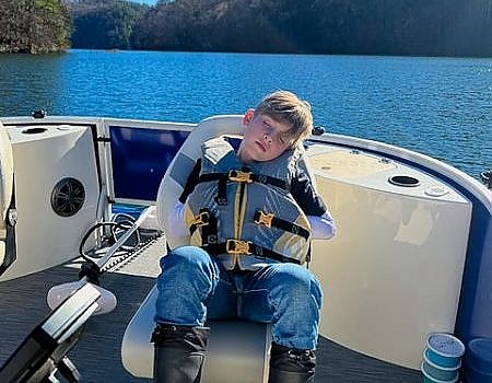 Boy sleeping on Lake adventure boat