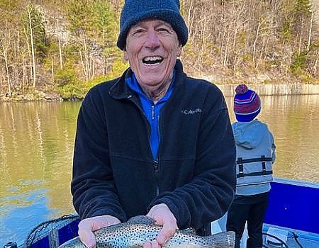 Older gentleman poses with fish caught during Blue Ridge fly-fishing trip