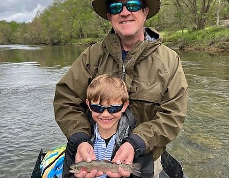 Father and son pose with fish caught on fly fishing trip